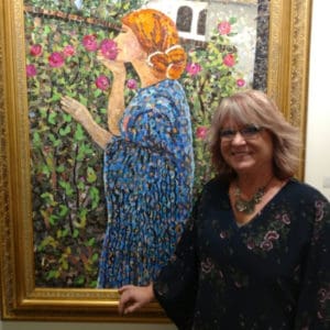 Artist Vivian Mosley with her painting of a lady smelling flowers