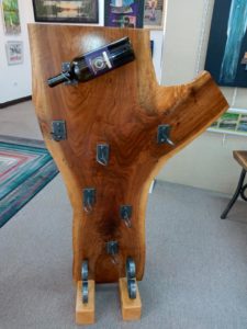 Wine bottle holder made of wood and metal by blacksmith Nathan Olinger