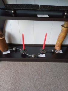 Metal candle holders by Nathan Olinger with red candles