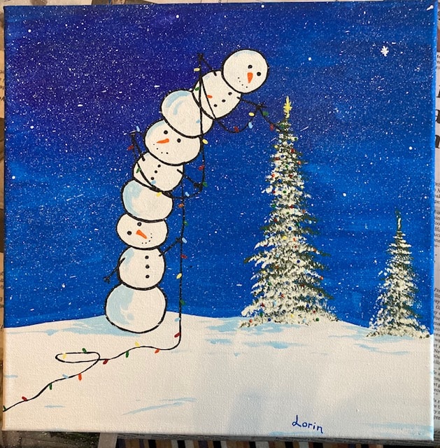 Painting of three snowmen stacked on top of each other hanging lights on a tree